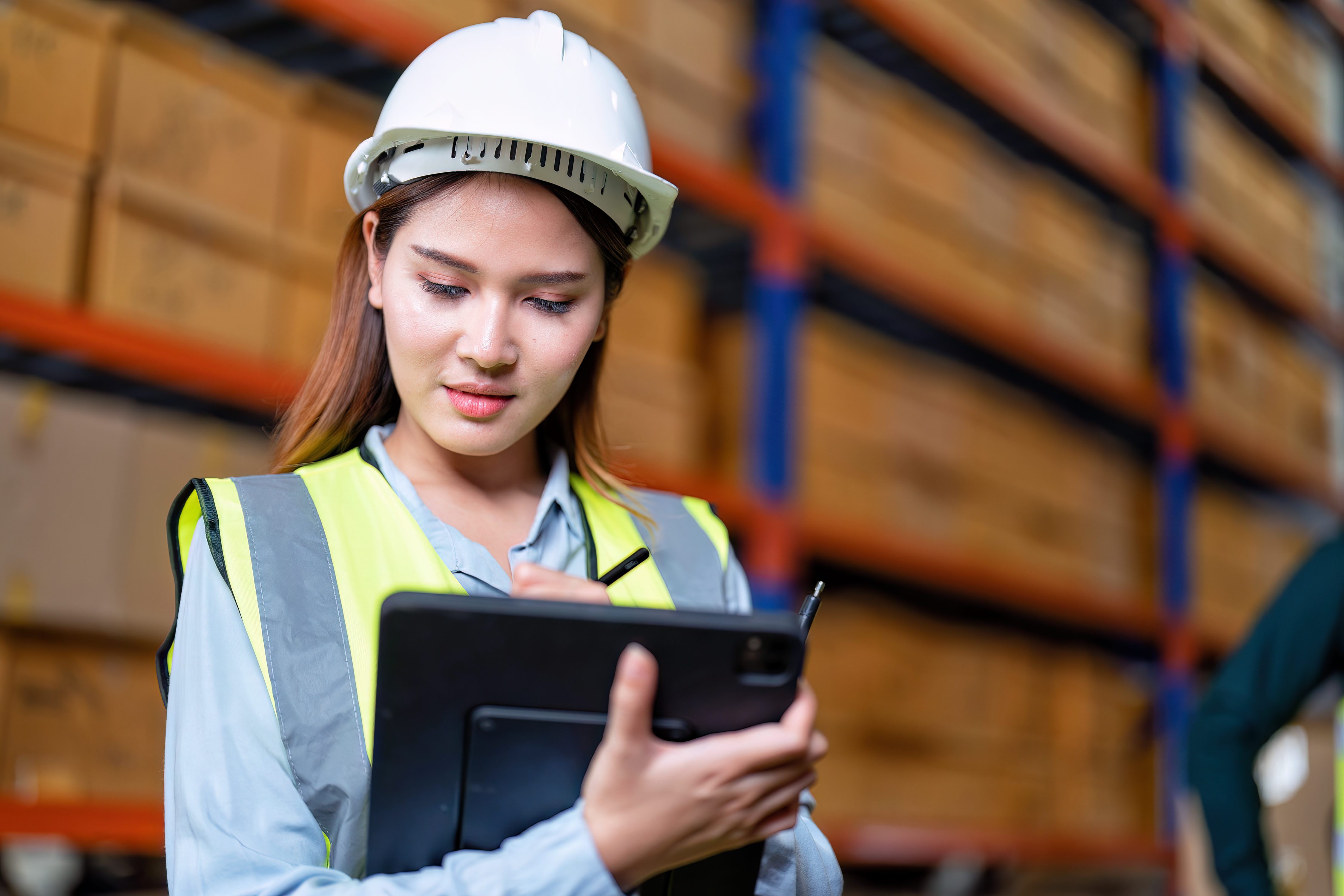 Worker in warehouse holding check list tablet pc stand portrait photo